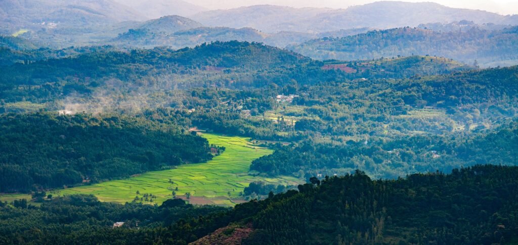 Beautiful Hill and Valley Landscape for Weekend Trips from Bangalore Scenic green valley surrounded by forest-covered hills, ideal for weekend trips from Bangalore and nature getaways in Karnataka