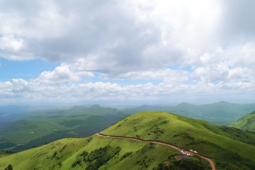 Coorg Hill Station – Misty Hills and Coffee Plantations of Karnataka Scenic Coorg hill station featuring lush coffee plantations, mist-covered hills, and vibrant green valleys in Karnataka